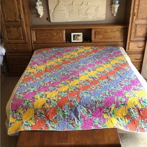 Homemade Quilt. 72”W x 94”L. Yellow, Pink, Blue, Orange with Flower print.
